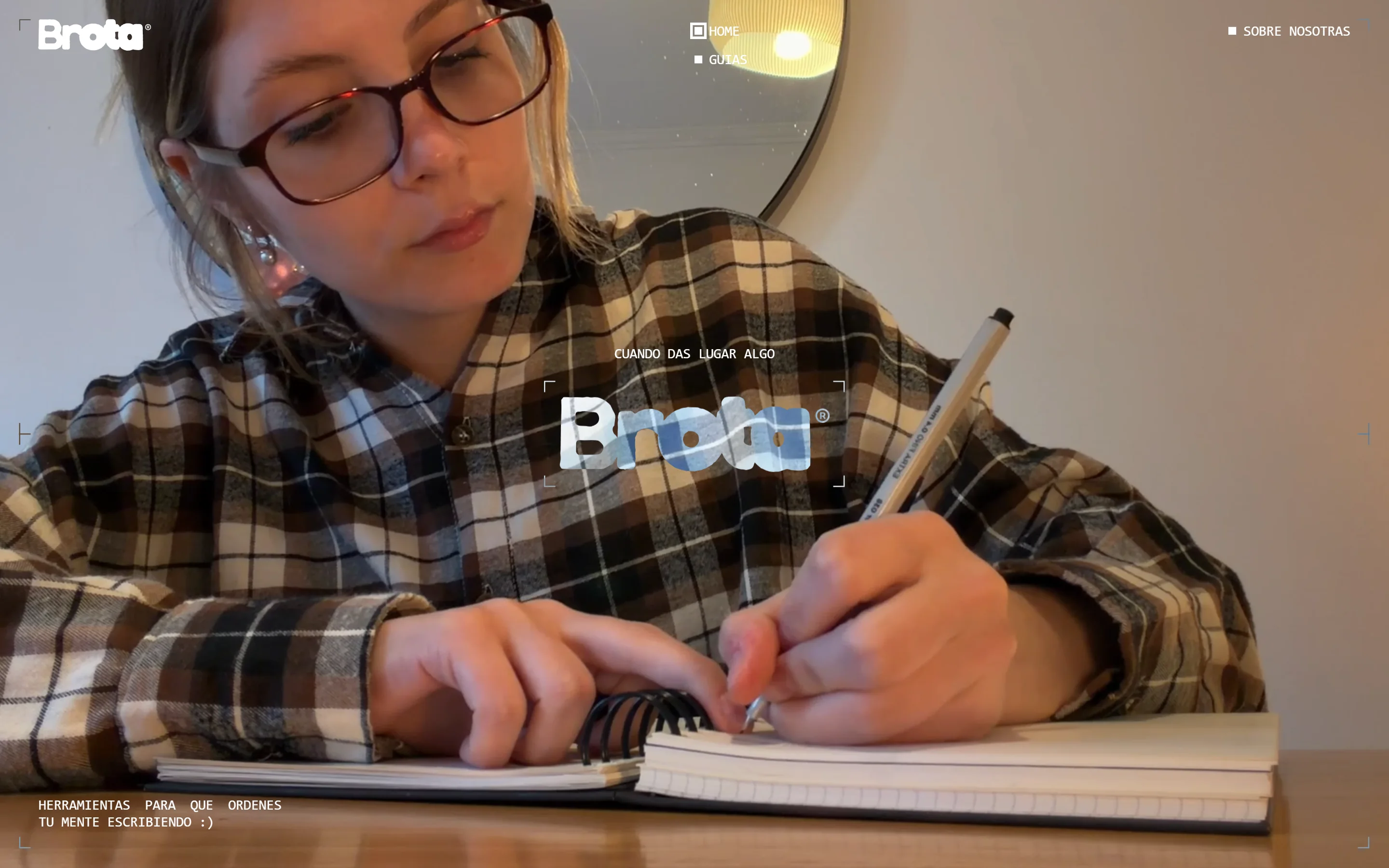 Brota home page on desktop: a woman writing in a notebook behind the Brota logo.