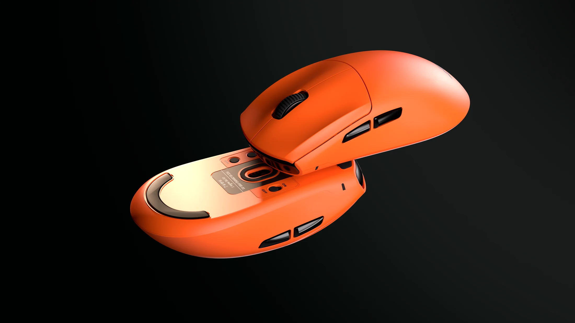 Two orange Flick Edge mice, one seen from above and one upside down, showing its skates and sensor.