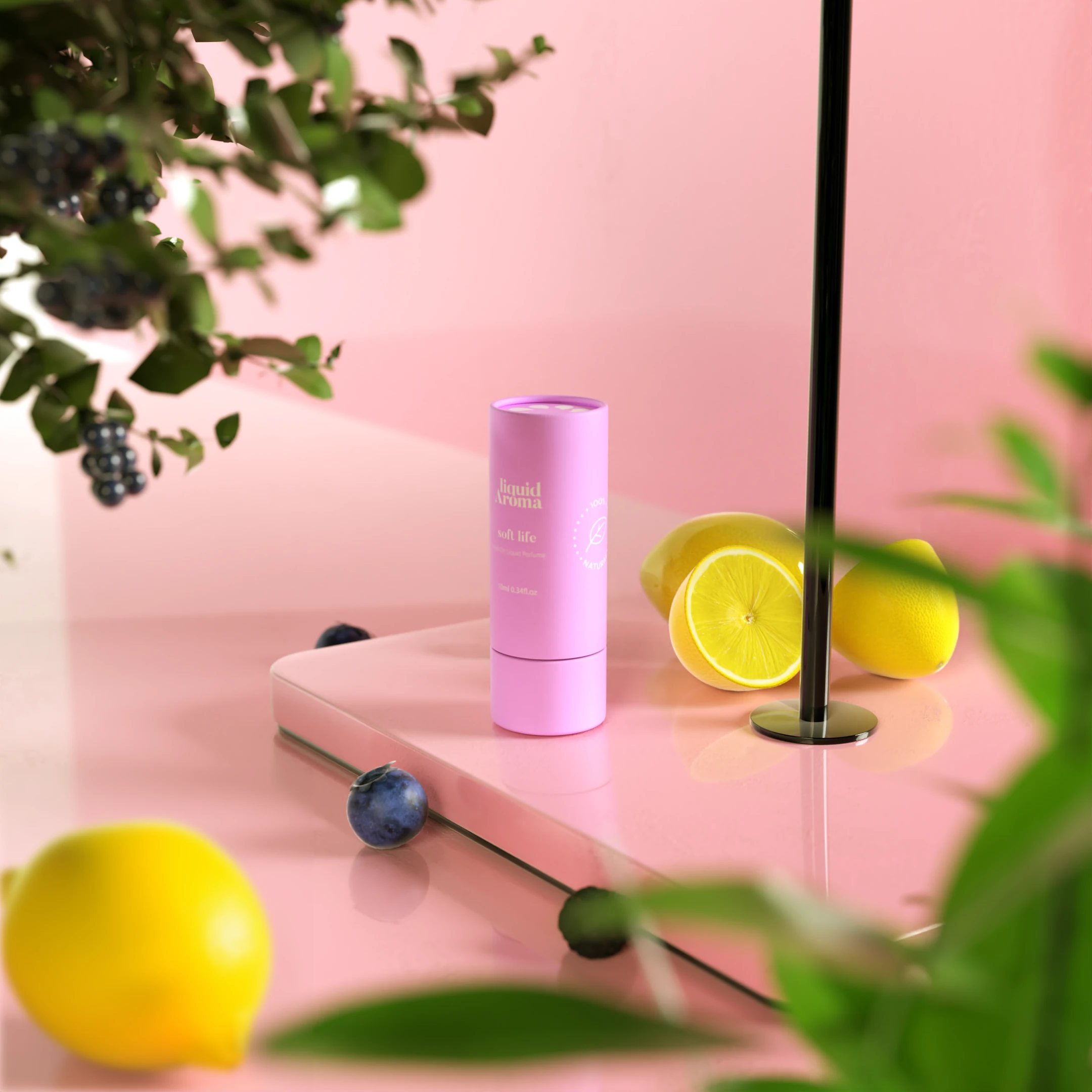 The pink Soft Life tube on a pink set with lemons, blackberries and leaves.